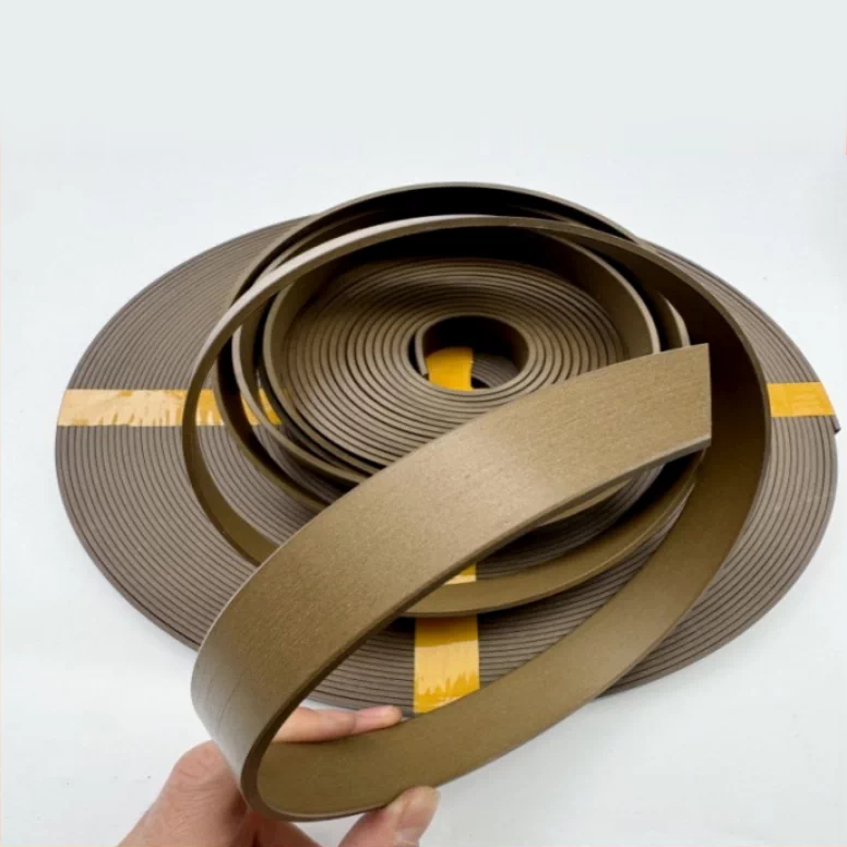 Bronze filled PTFE guide-strip coil with a loose band held forward