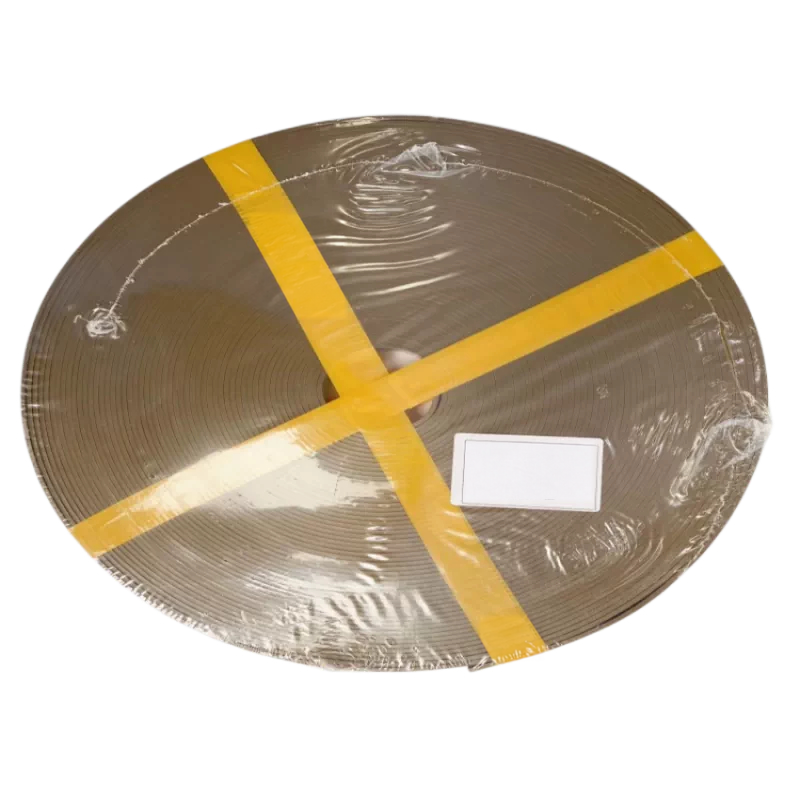 A wrapped bronze filled PTFE strip coil secured with yellow tape