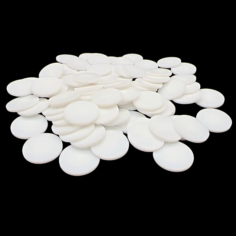 White solid PTFE discs stacked to show the flat faces and edges