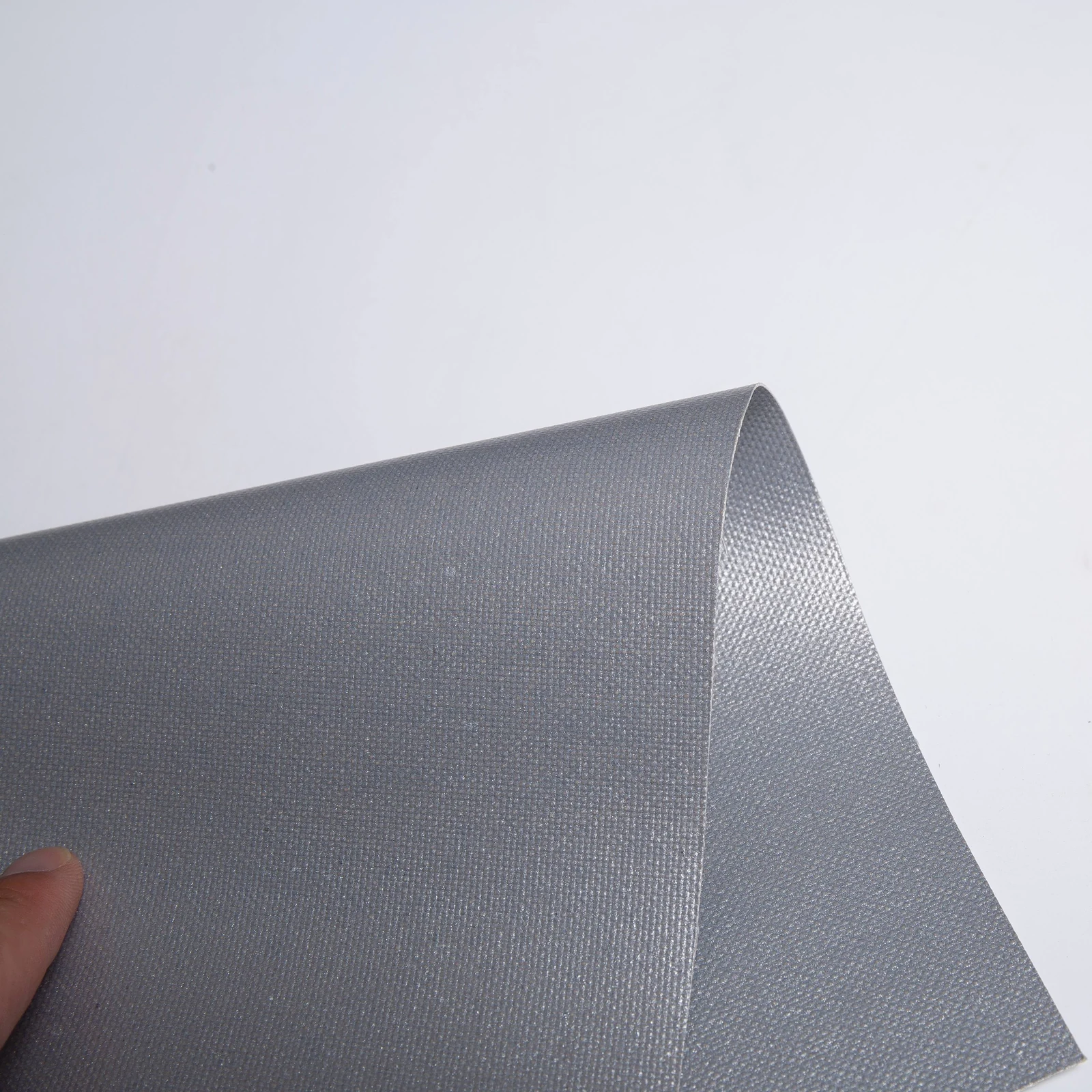 Gray coated fabric bent into a broad curve